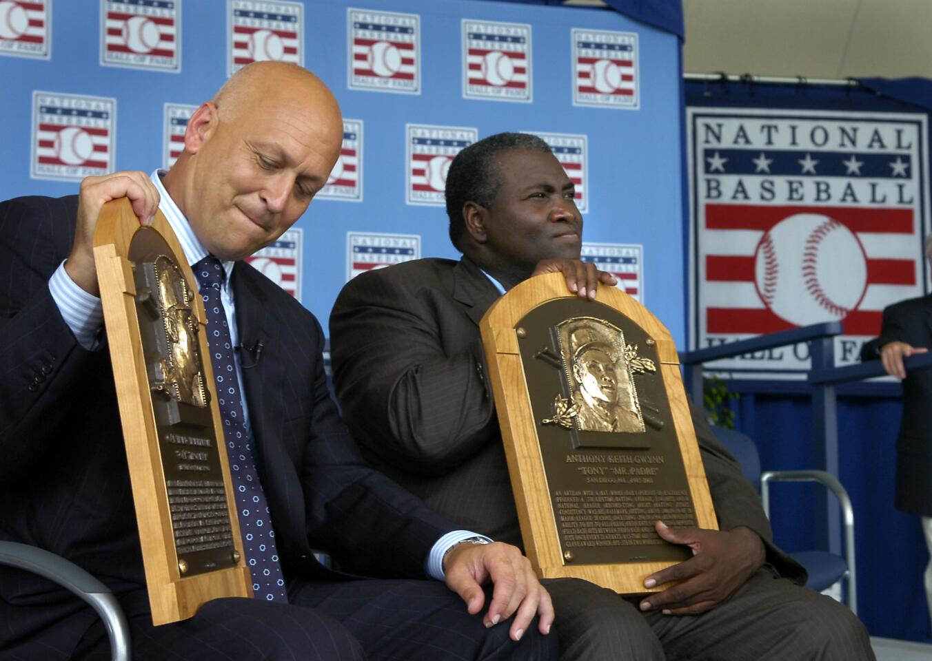 Cal Ripken Jr. holds his Baseball Hall of Fame plaque along with former San Diego Padre Tony Gwynn after their induction.