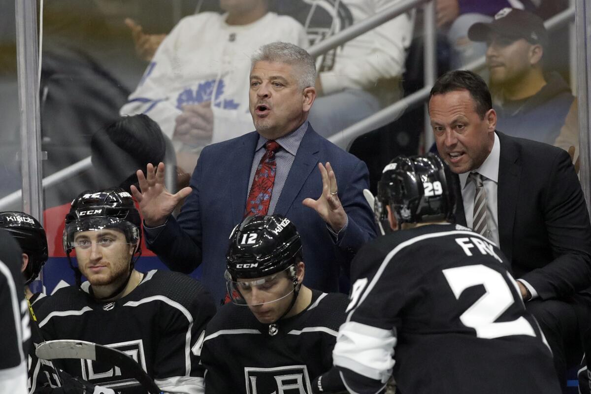 Kings coach Todd McLellan, center, and assistant coach Marco Sturm instruct players during a game against the Toronto Maple Leafs on March 5.
