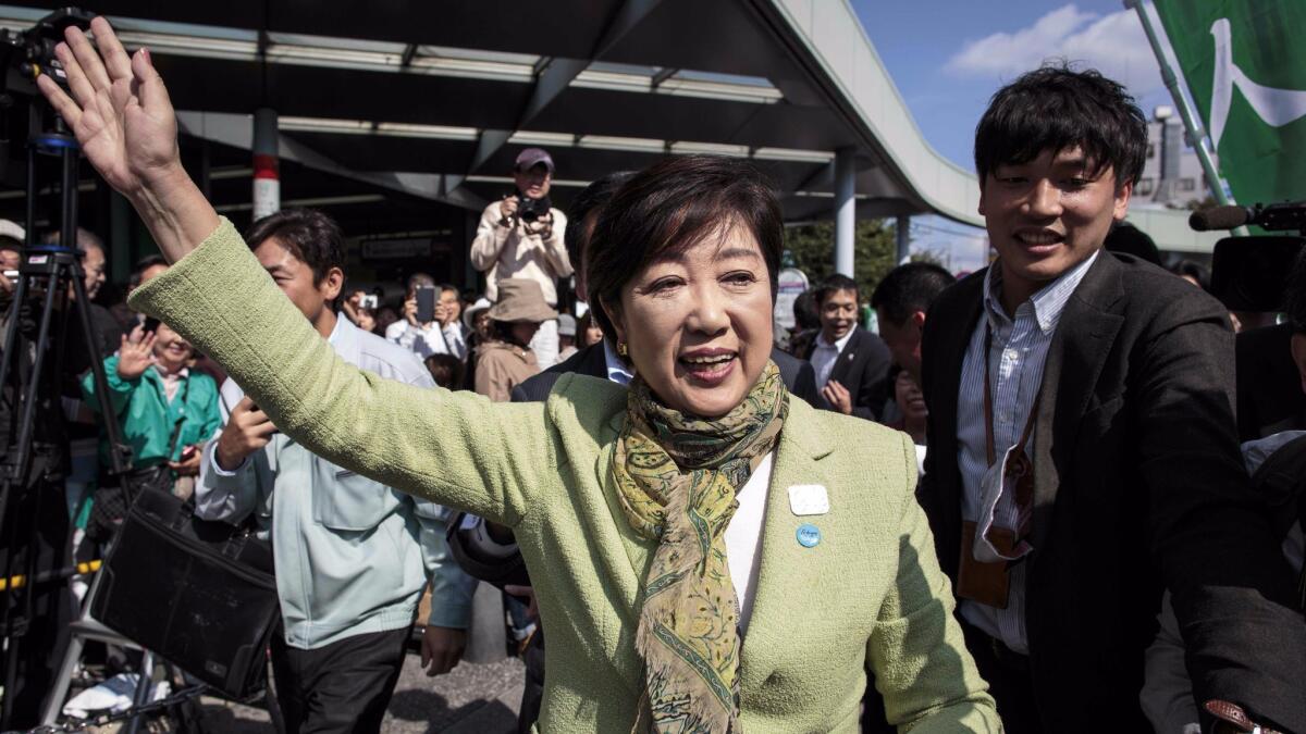 Tokyo Gov. Yuriko Koike greets her supporters during a campaign appearance Wednesday in Saitama.