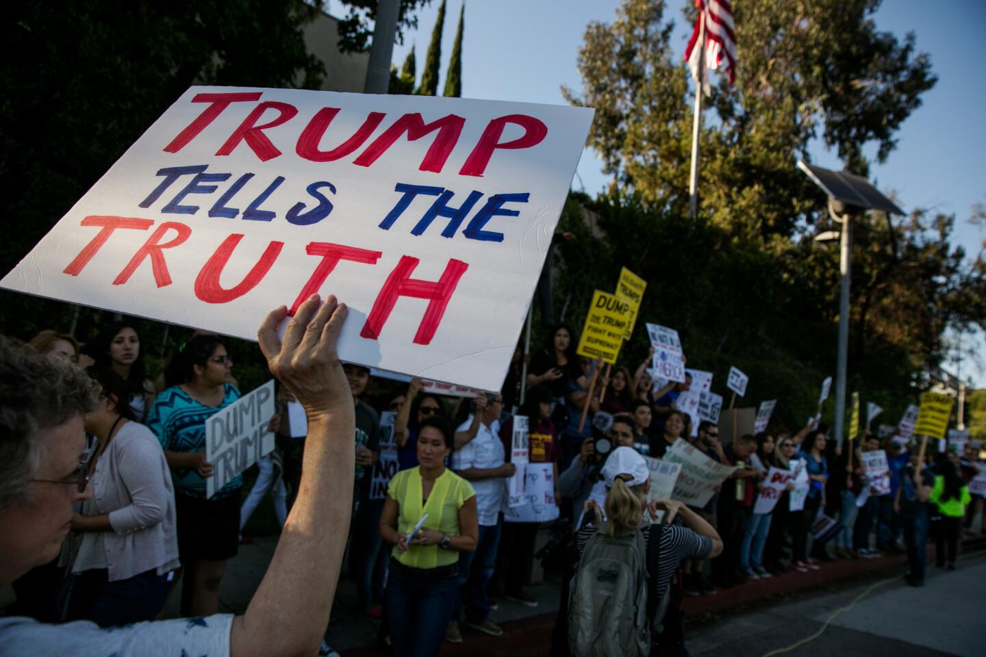 Donald Trump supporters pass rival demonstrators outside the Luxe Sunset Boulevard Hotel.