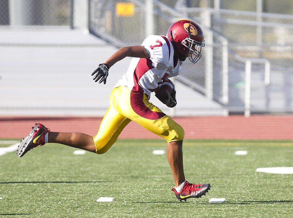 Estancia's Jaycen Cash runs to the end zone for a touchdown against Costa Mesa during the frosh-soph Battle for the Bell on Thursday.