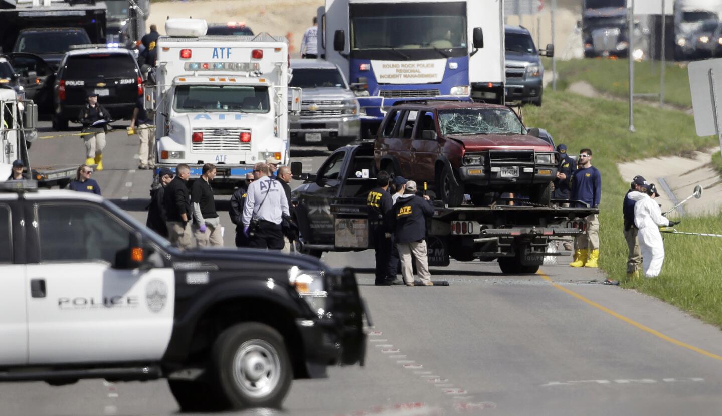 Officials remove a car of the suspect in a series of bombing attacks in Austin from the scene where he blew himself up in Round Rock, Texas on March 21.