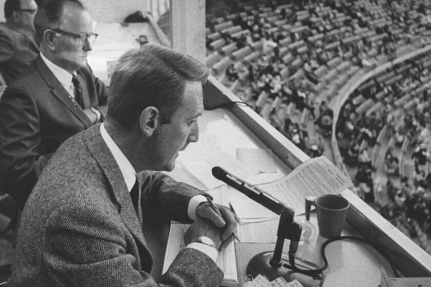 1967 file photo of Dodger announcer Vin Scully (foreground) with his announcing teamate Jerry Doggett. - Associated Press