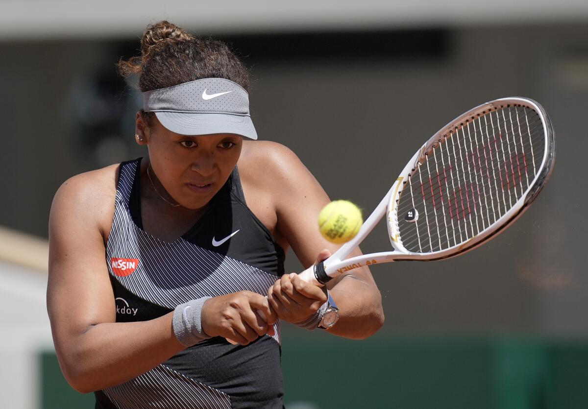 Naomi Osaka hits the ball Open.