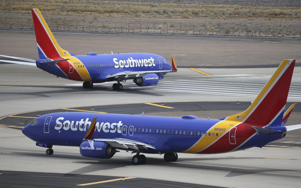 FILE - Southwest Airlines planes taxi at Phoenix Sky Harbor International Airport in Phoenix, July 17, 2019. Southwest Airlines said Thursday, Sept. 15, 2022, that corporate travel is recovering more slowly than the airline had expected, although that is offset by continuing strong demand from leisure travelers even after the end of the traditional summer vacation season. (AP Photo/Ross D. Franklin, File)