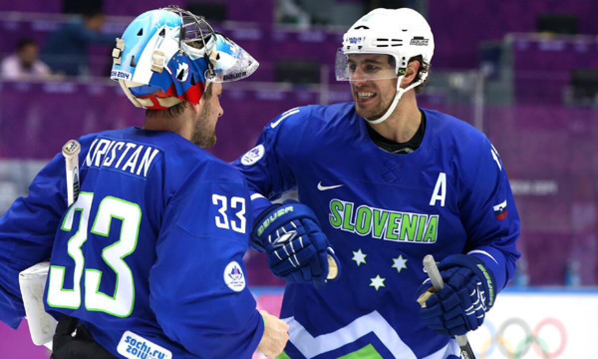 Slovenia goalie Robert Kristan, left, celebrates with teammate Anze Kopitar following a 4-0 win over Austria at the Sochi Winter Olympic Games on Tuesday.