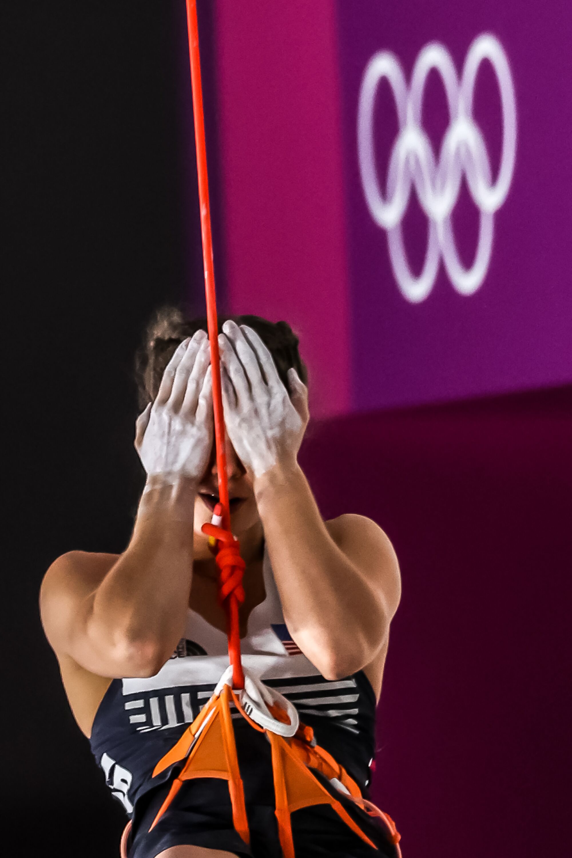 USA climber Brooke Raboutou covers her face as she descends from the lead wall