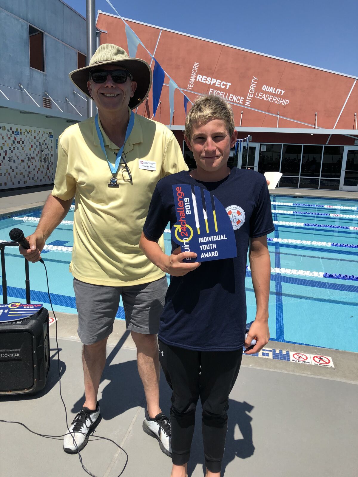 Corey McClelland, president and CEO at Prevent Drowning Foundation presents the top youth award to Rancho San Dieguito swimmer Sébastien Wenger.