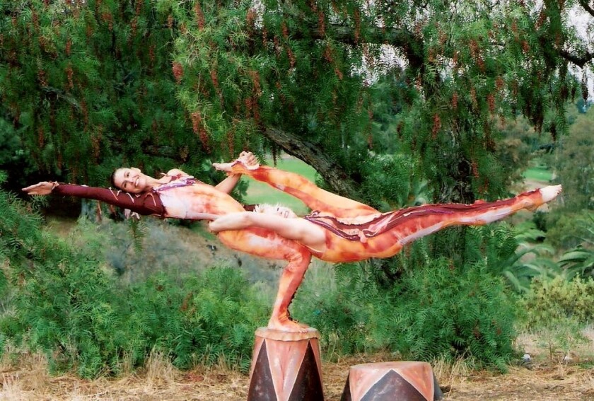 The strength involved in partner balancing is showcased by Art in Flexion instructor Cheryl Lindley and Annetta Lucero.