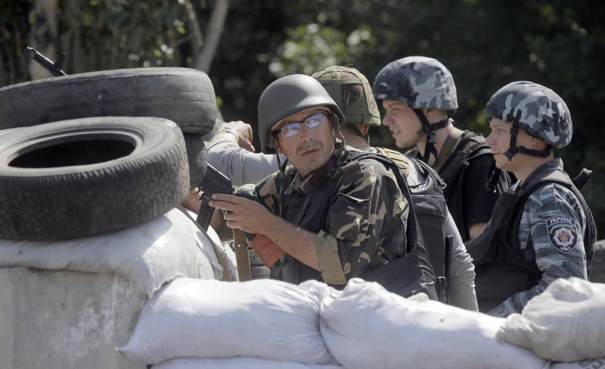 Ukrainian soldiers behind their barricade near the separatist-held town of Slovyansk in eastern Ukraine on Wednesday.