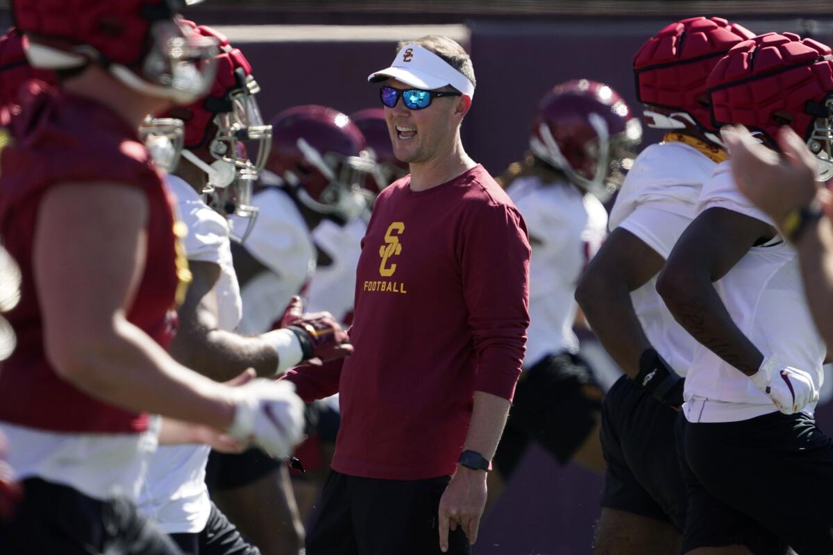 FILE - Southern California coach Lincoln Riley talks to player as they warm up during an NCAA college football practice March 24, 2022, in Los Angeles. (AP Photo/Mark J. Terrill, File)