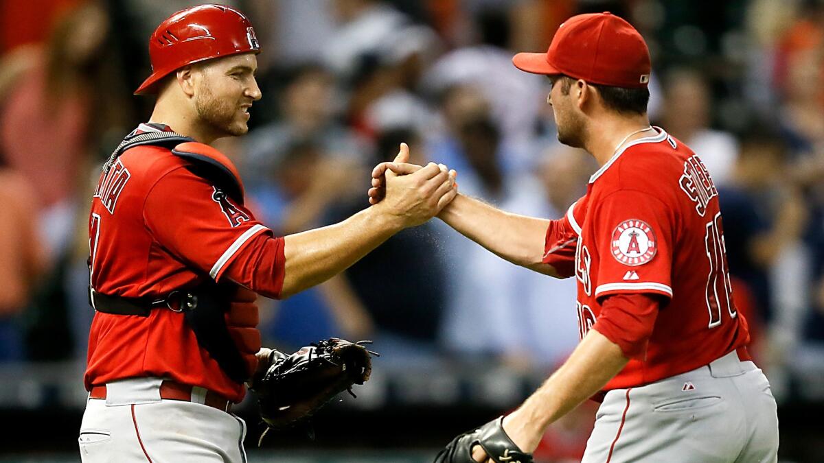 Angels catcher Chris Iannetta and closer Huston Street celebrate after defeating the Astros on Wednesday night in Houston.