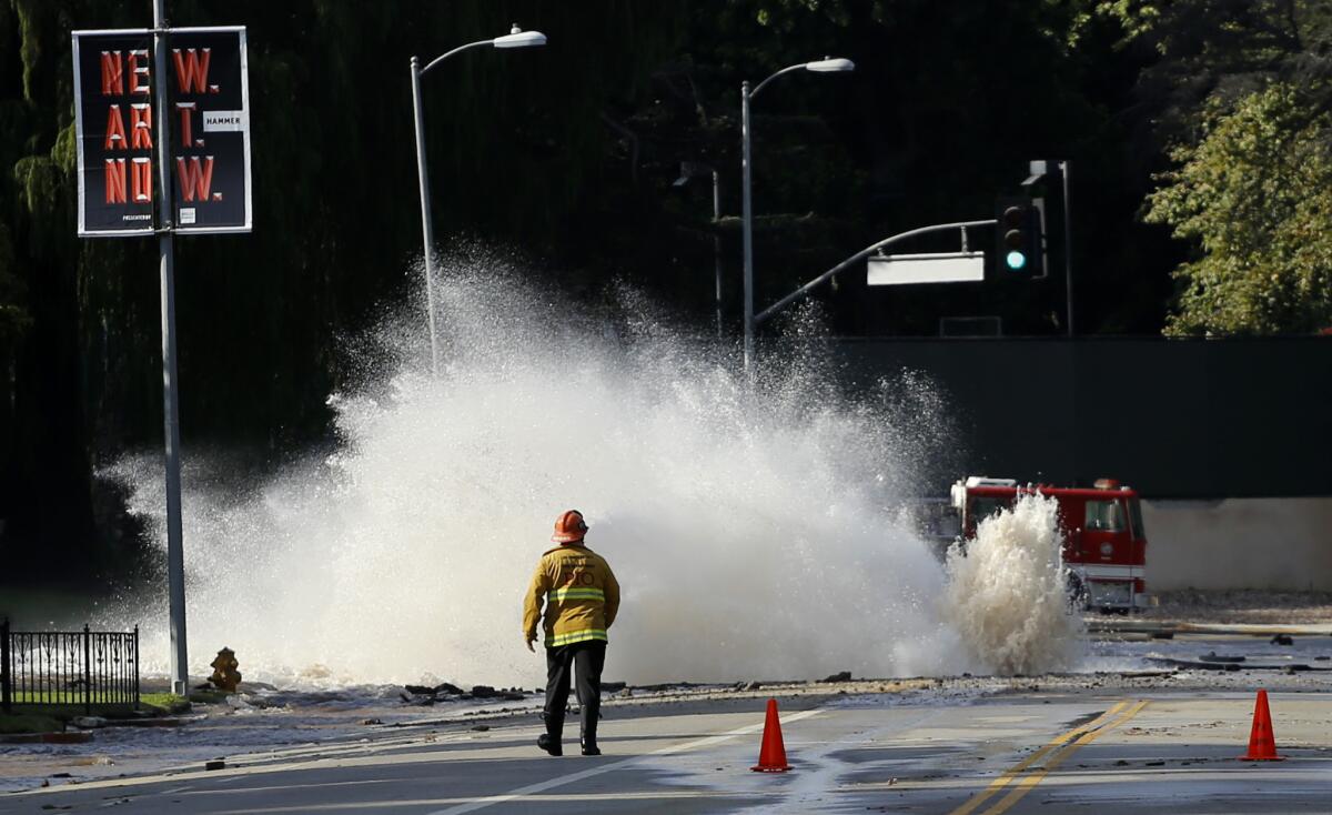 Water gushes from a broken pipe on Sunset Boulevard near UCLA in July 2014, flooding portions of the campus.