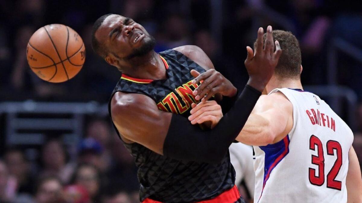 Hawks forward Paul Millsap, left, reacts after being fouled by Clippers forward Blake Griffin during the first half on Feb. 15.