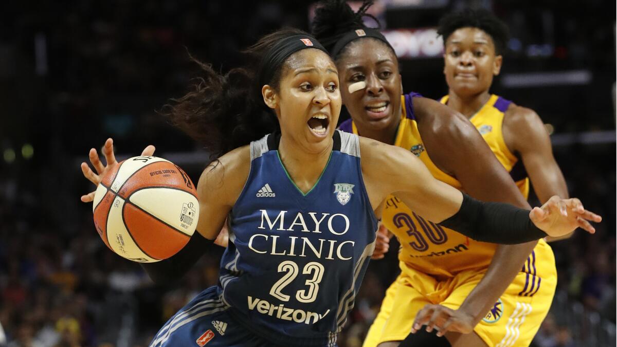 Lynx forward Maya Moore drives to the basket against Sparks forward Nneka Ogwumike during the fourth quarter.