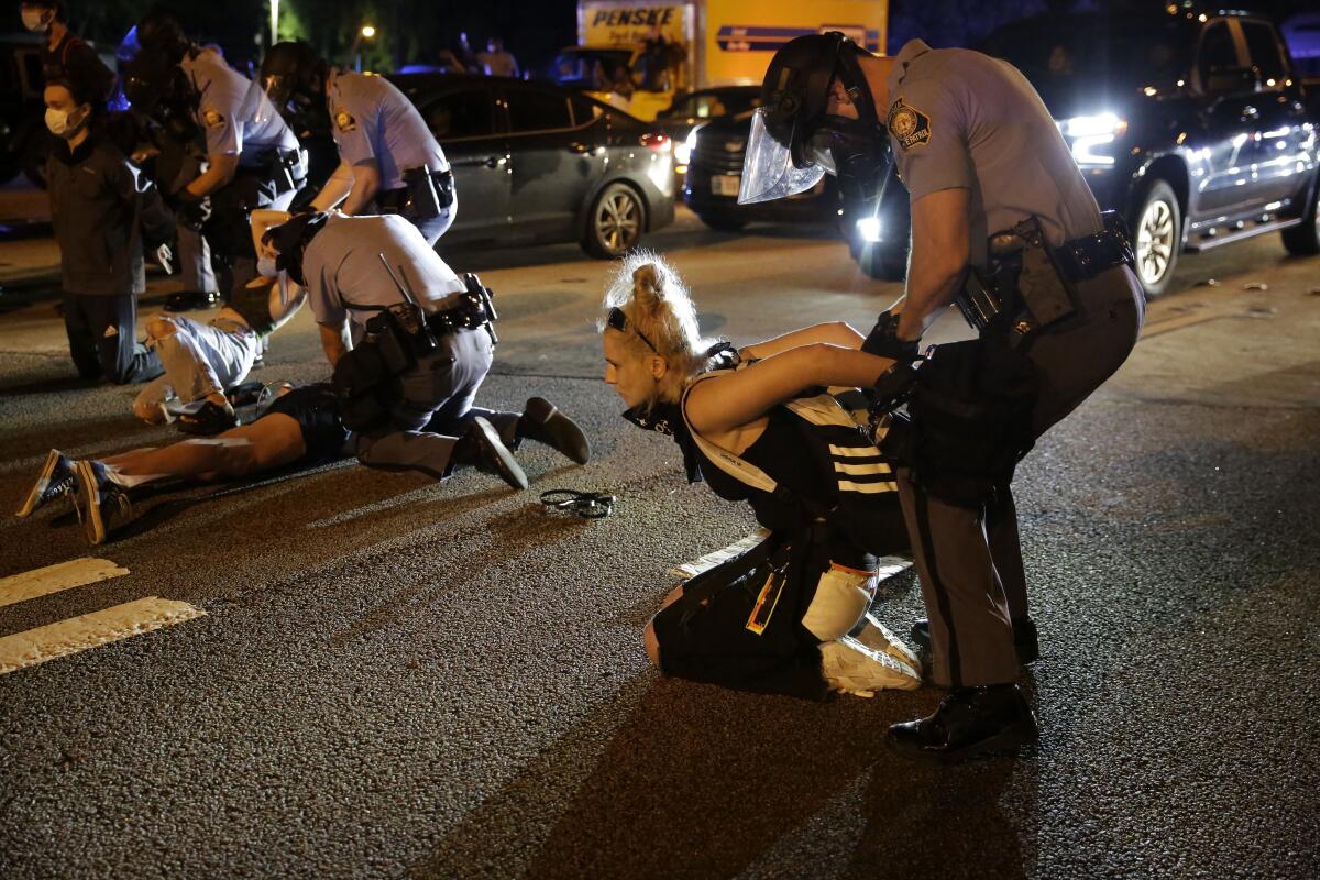 People are detained during protests Saturday near the Atlanta Wendy's where Rayshard Brooks was shot and killed by police.