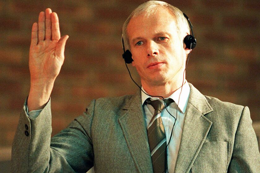 FILE - Janusz Walus, Polish immigrant and convicted killer of South African Communist Party leader Chris Hani, is sworn in during a Truth and Reconcilliation Commission hearing in Pretoria, South Africa, on Nov. 24, 1997. Walus has been released from prison in the capital Pretoria after serving more than 28 years for the 1993 murder. (AP Photo/Cobus Bodenstein, File)