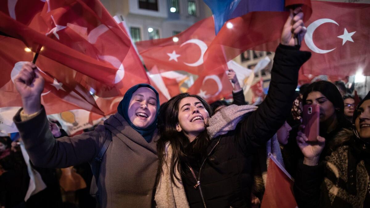 Supporters of the Justice and Development Party wave Turkish flags as they celebrate early results for the Istanbul mayoral race on Sunday.