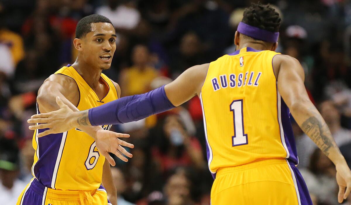 Lakers guard Jordan Clarkson, left, is saluted by teammate D'Angelo Russell after scoring against the Atlanta Hawks during the second quarter Wednesday.
