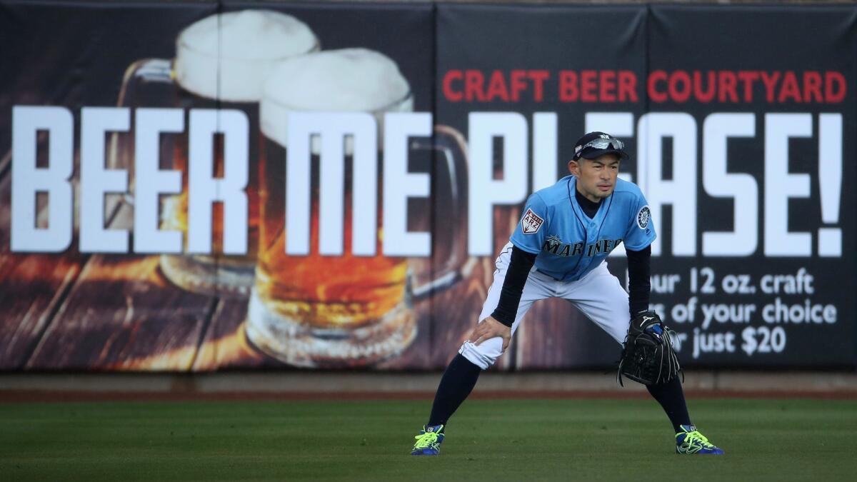 An ad for craft beer frames outfielder Ichiro Suzuki of the Seattle Mariners during an MLB spring training game Friday against the Oakland Athletics at Peoria Stadium