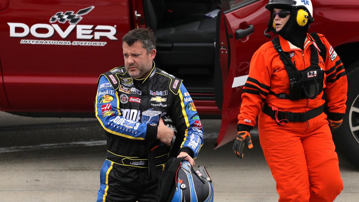 NASCAR driver Tony Stewart walks off of the track at Dover International Speedway after a crash during qualifying on Friday.