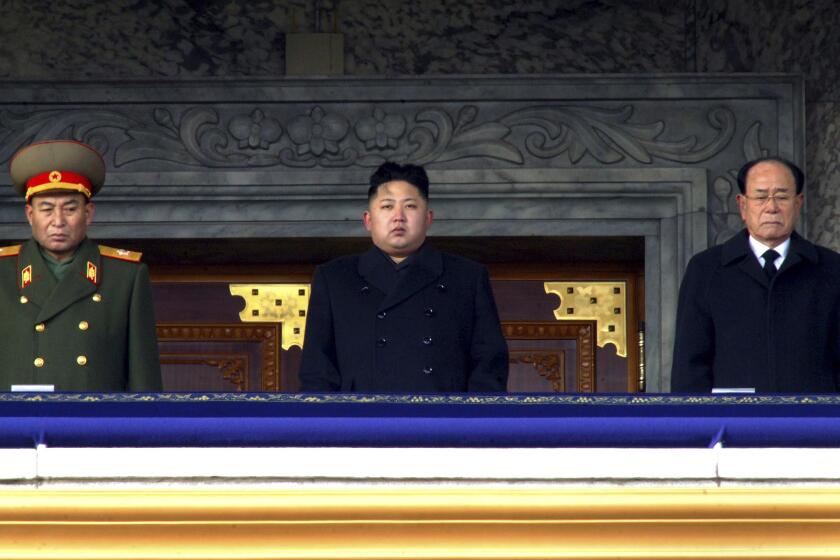 FILE - New North Korean leader Kim Jong Un, center, flanked by Kim Yong Nam, president of the Presidium of the Supreme People's Assembly and the ceremonial head of state, right, and Ri Yong Ho, a vice marshal of the Korean People's Army, presides over a national memorial service for his late father Kim Jong Il at Kim Il Sung Square in Pyongyang, North Korea on Dec. 29, 2011. It's been 10 years since Kim Jong Un took power in North Korea after his father suddenly died of a heart attack. (AP Photo/File)