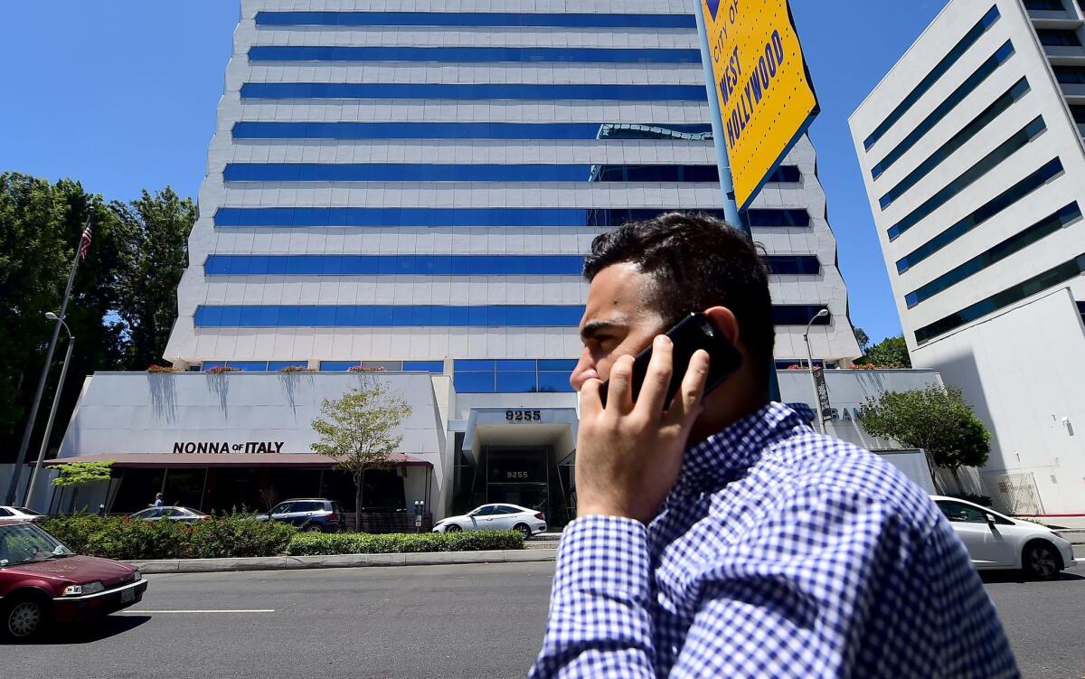 A pedestrian speaks on his cellphone while walking on Sunset Boulevard in West Hollywood on July 20.