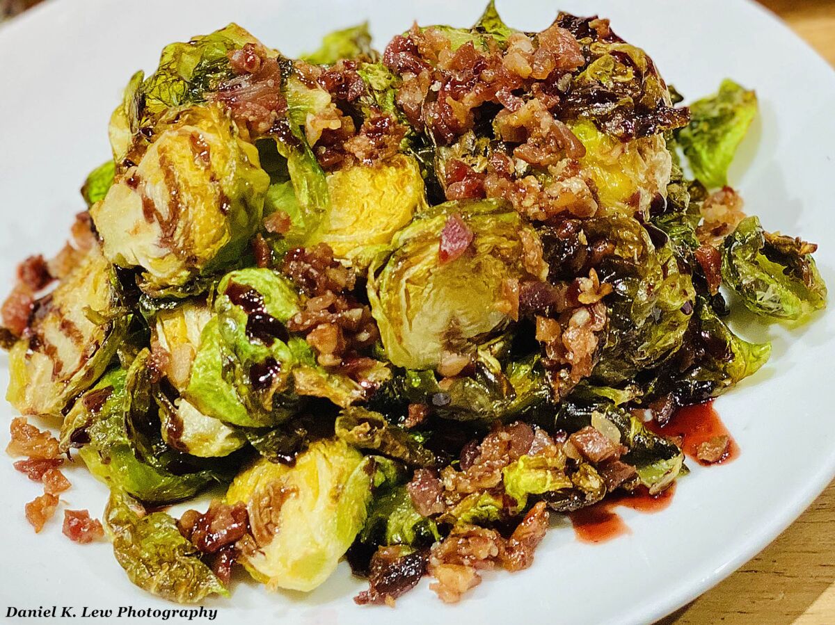 Sauteed brussel sprouts topped with bacon and boysenberry balsamic is among the unique foods offered during Knott's Boysenberry Festival, March 20-April 19, 2020 at Knott's Berry Farm theme park in Buena Park, California.