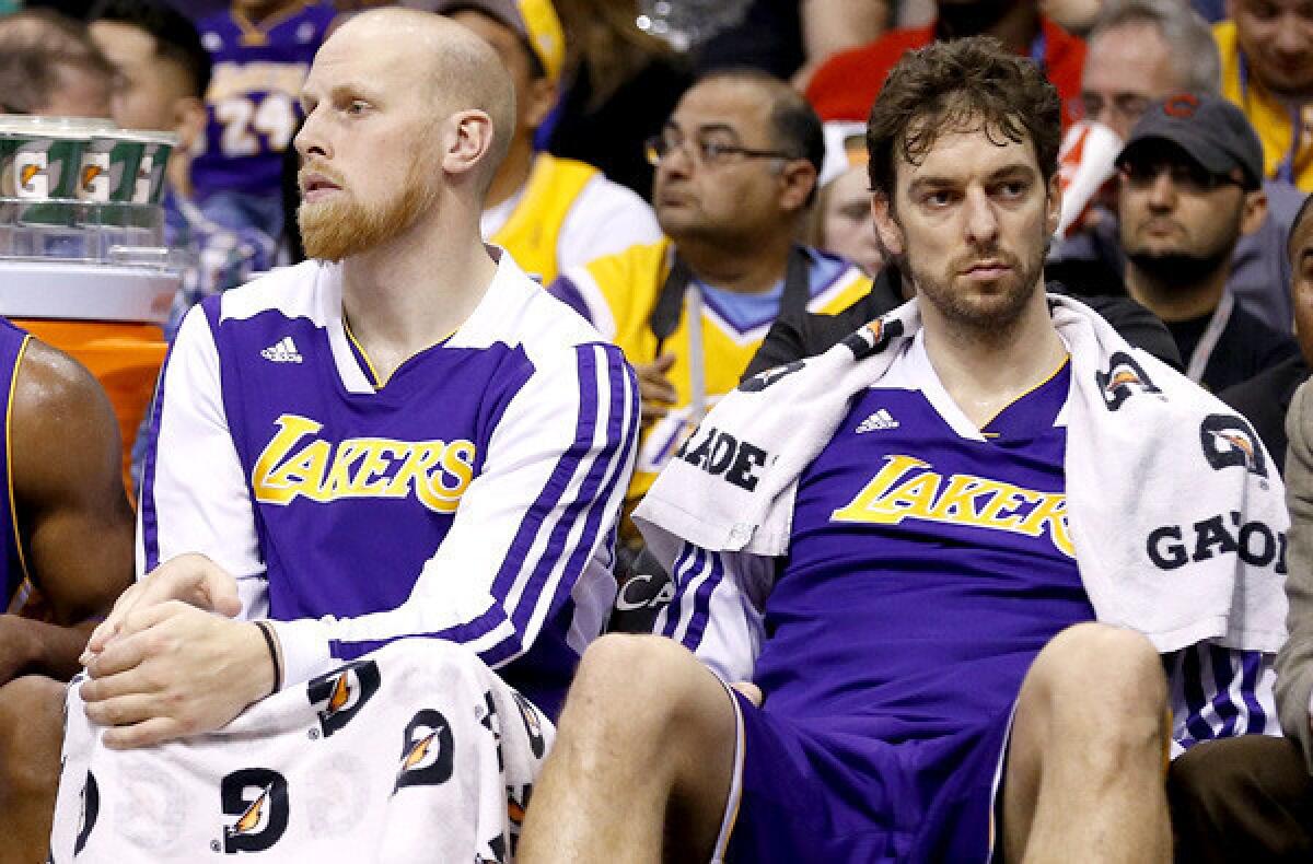 Lakers big men Chris Kaman, left, and Pau Gasol might not be available for Sunday night's game against the Philadelphia 76ers.