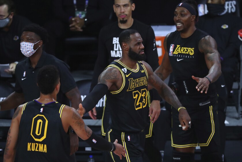 Los Angeles Lakers forward LeBron James (23) reacts with forward Kyle Kuzma (0) in the first half of Game 4.