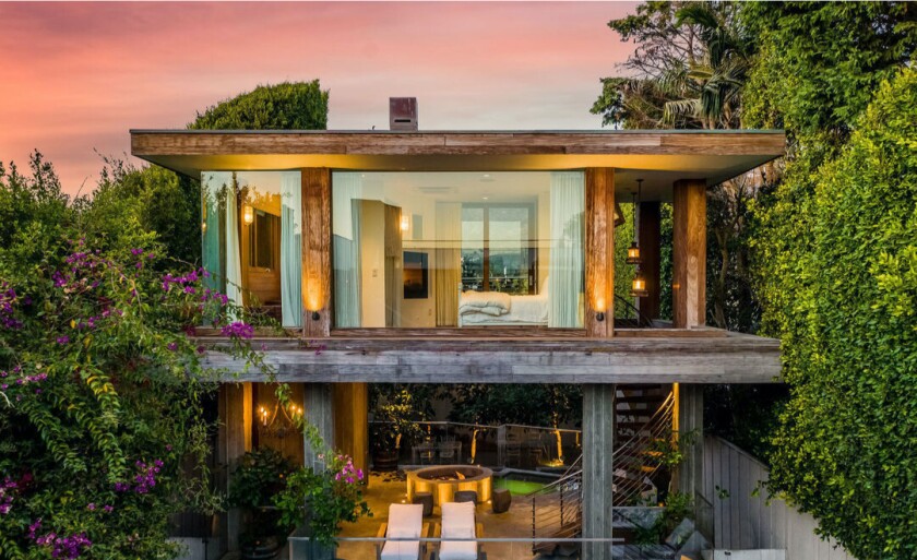 Overlooking Malibu Lagoon, the mini compound holds a 5,500-square-foot main house and one-bedroom guesthouse.