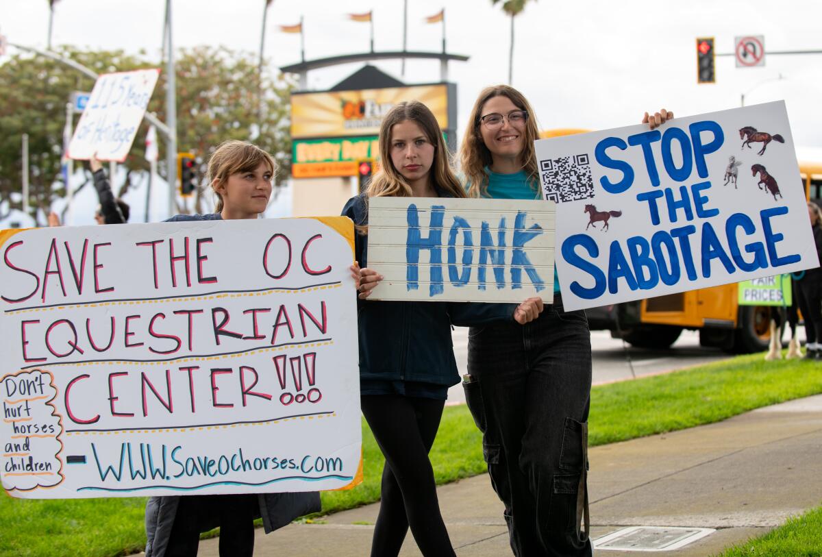 Youth outside Costa Mesa City Hall Thursday protest horse boarding rate increases.