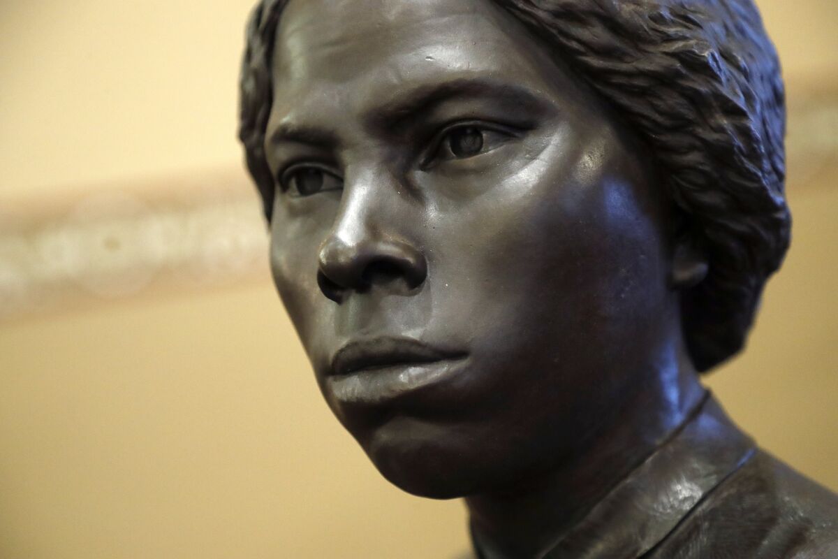 A bronze statue of abolitionist Harriet Tubman is shown.