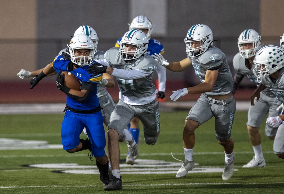 Fountain Valley's Tyler Arevalos runs up field on a kickoff return against Aliso Niguel in a nonleague game on Friday.