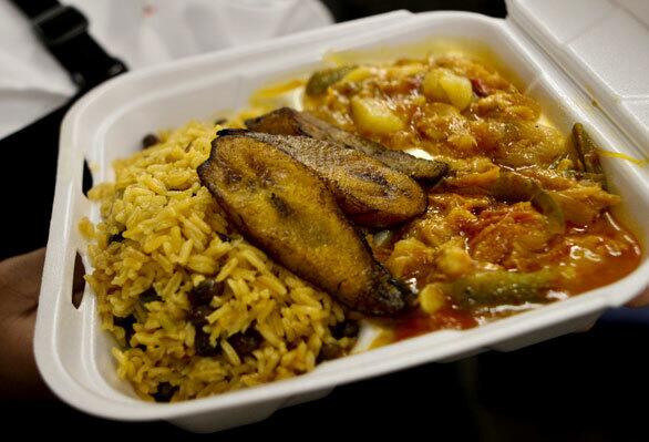 Bacalao con papas, which is salt cod with potatoes, served with rice and beans and fried plantains.
