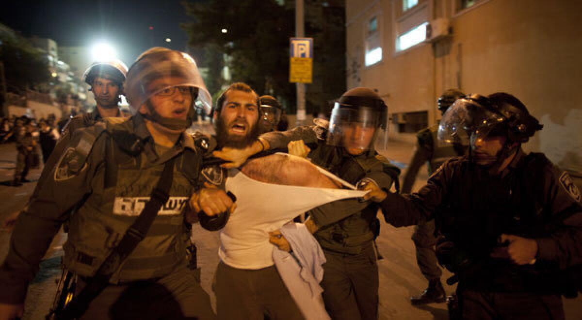 Israeli riot police arrest an ultra-Orthodox demonstrator on May 16, 2013 in Jerusalem, Israel. Tens of Thousands of ultra-Orthodox Israelis have clashed with police after gathering to protest against newly proposed government legislation that would see them drafted into the military.