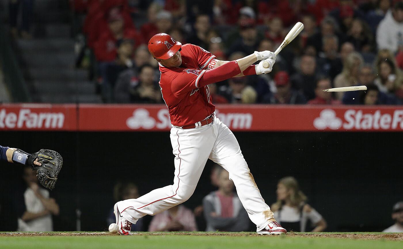 Angels first baseman C.J. Cron's bat splinters as he fouls off a ball against the Seattle Mariners in the seventh inning.