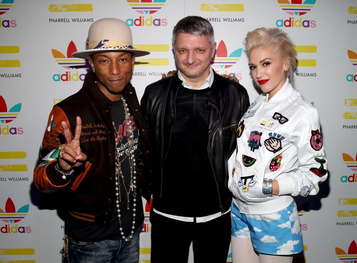 Pharrell Williams, left, Adidas Sport Style Division creative director Dirk Schonberger and singer Gwen Stefani attend the collaboration celebration of Pharrell Williams and Adidas at Hinoki & the Bird on Wednesday in Los Angeles.