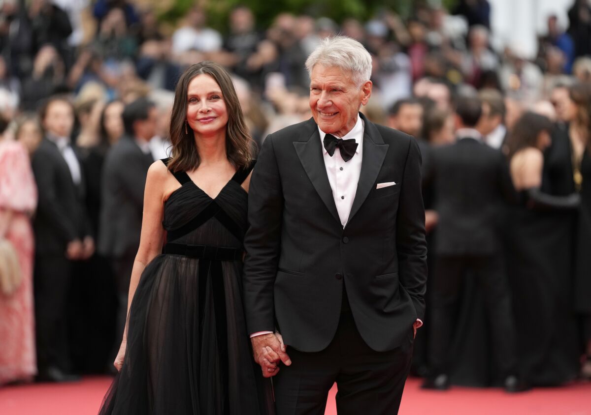 Calista Flockhart, left, and Harrison Ford pose for photographers upon arrival at the premiere of the film 'Indiana Jones and the Dial of Destiny' at the 76th international film festival, Cannes, southern France, Thursday, May 18, 2023. (Photo by Scott Garfitt/Invision/AP)