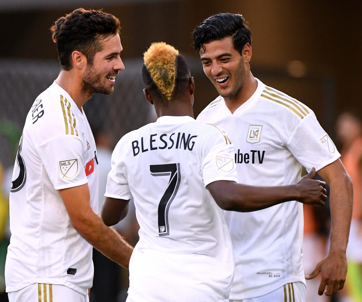 LOS ANGELES, CA - MAY 13: Carlos Vela #10 of Los Angeles FC celebrates his goal with Latif Blessing #7, and Benny Feilhaber #33 to take a 2-1 lead over New York City FC during the second half at Banc of California Stadium on May 13, 2018 in Los Angeles, California. The game ended 2-2.