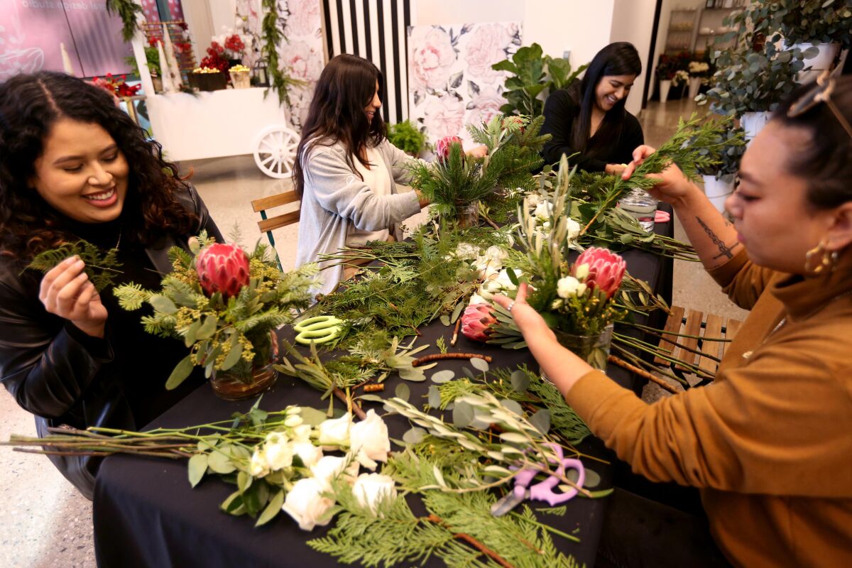Four women learn how to make floral arrangements at the Water Garden office complex in Santa Monica.