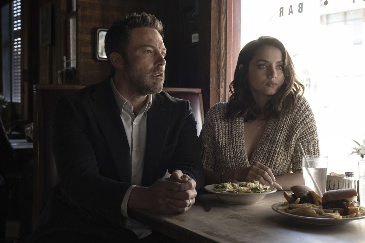 This image released by 20th Century Studios shows Ben Affleck, left, and Ana de Armas in a scene from "Deep Water." (Claire Folger/20th Century Studios via AP)