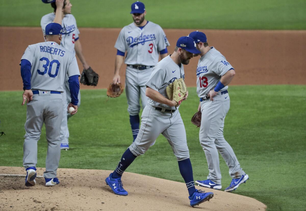 Dodgers manager Dave Roberts removes relief pitcher Adam Kolarek from the game.