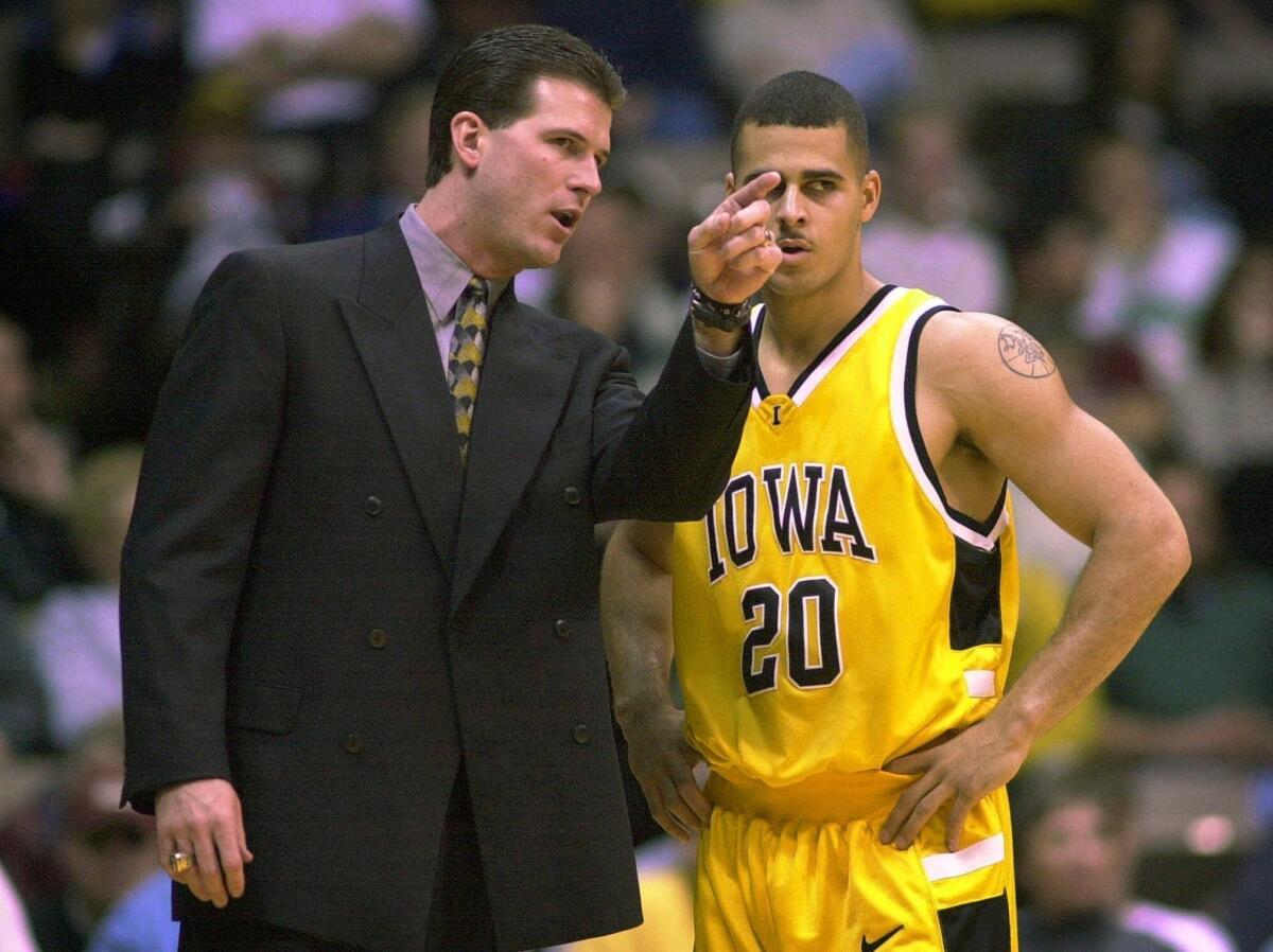 Steve Alford, as coach of Iowa in 2006, talks to guard Dean Oliver during a game. Alford led Iowa to a 25-9 record that year, including the Hawkeyes' second Big Ten Conference tournament championship.