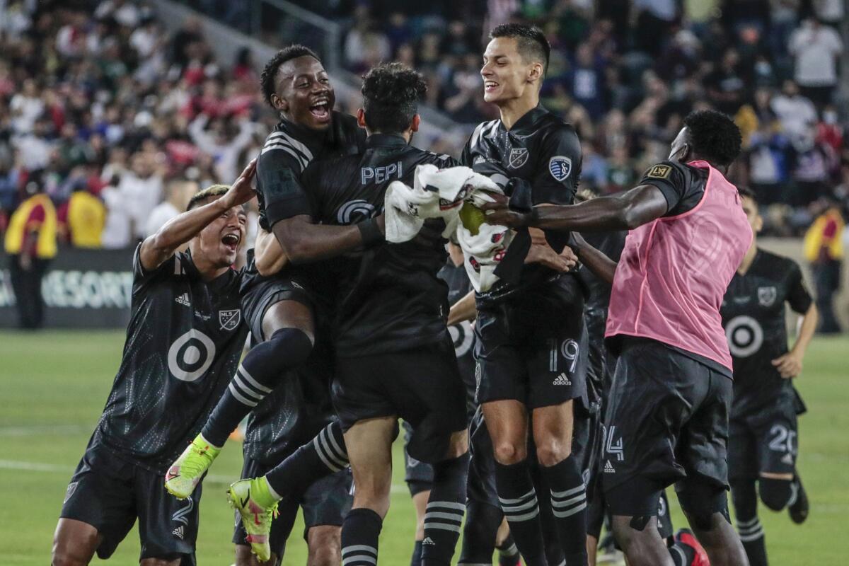 MLS teammates swarm Ricardo Pepe after he scored the clinching penalty kick to beat Liga MX