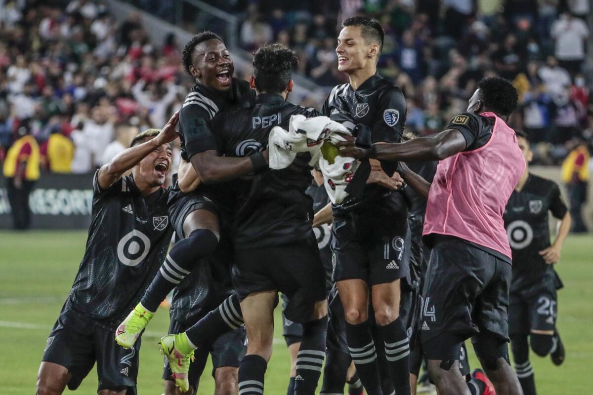 MLS teammates swarm Ricardo Pepe after he scored the clinching penalty kick to beat Liga MX 