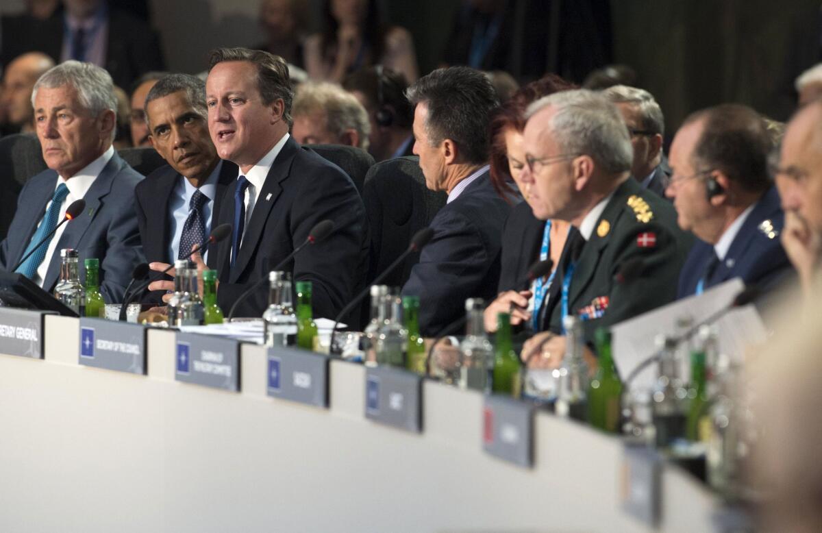 British Prime Minister David Cameron speaks as he sits alongside President Obama at the NATO summit in Newport, Wales, on Sept. 5.