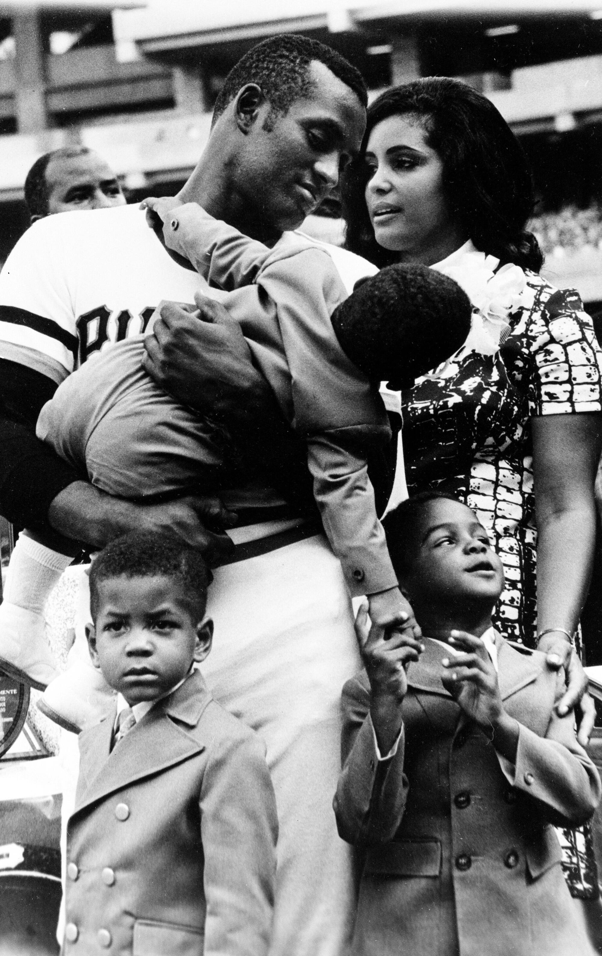 Roberto Clemente holds son Roberto Jr. while standing with his wife, Vera, and their two older sons Luis, left, and Enrique