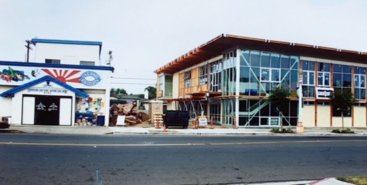 Ocean Beach People’s Organic Food Market's new building (right) goes up next to its old location on Voltaire Street in 2002.