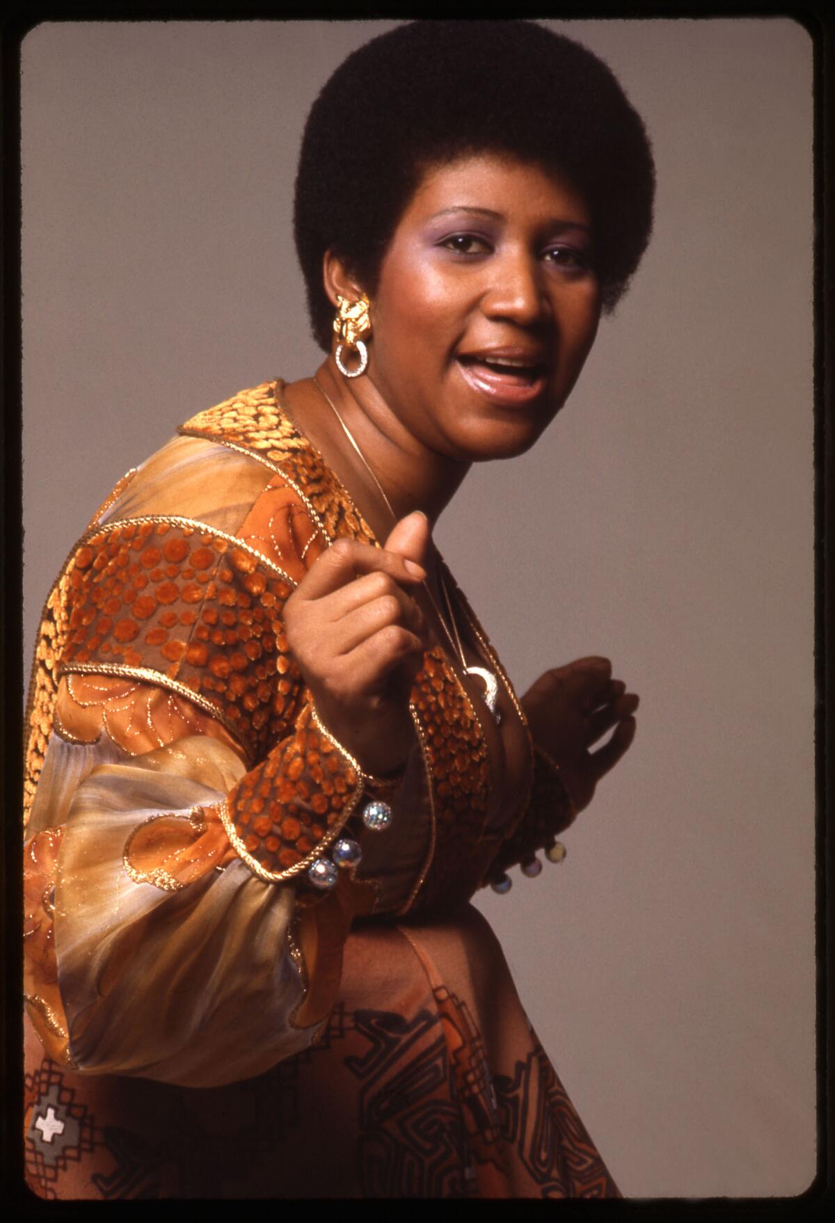 A woman in a multicolored tunic